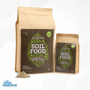 Two Ecothrive Soil Food Grow bags (5 kg and 1 kg) standing side by side with a small heap of powder top‑dressing in front – thegrowsuperstore.com