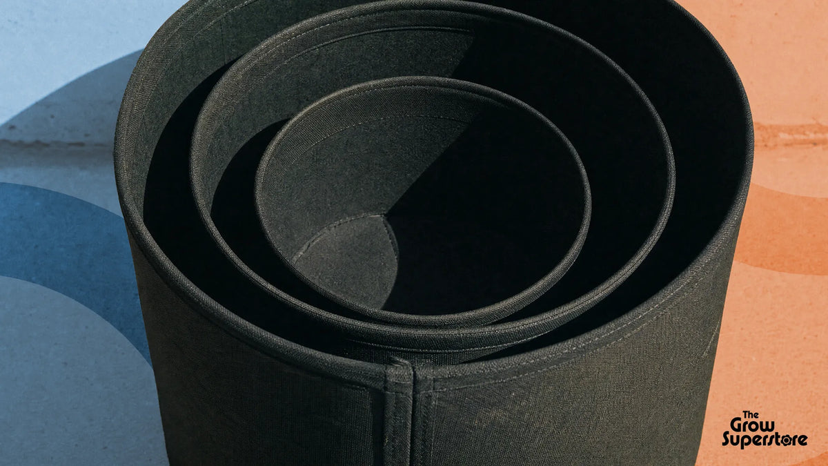Nested empty black fabric pots in a concentric size ladder
