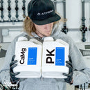 Athena Blended Line CaMg and PK 1-gallon bottles held by a person wearing Athena hat and gloves – thegrowsuperstore.com