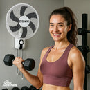 Woman working out in home gym with Cyclone 16-inch Wall Fan mounted on wall in background