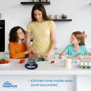 Mum using a digital kitchen scale to prepare vegetables with her two daughters in a bright family kitchen. Featuring the Precise PS5000 scale with LCD display and 2L bowl. Ideal for accurate, family-friendly cooking. – thegrowsuperstore.com